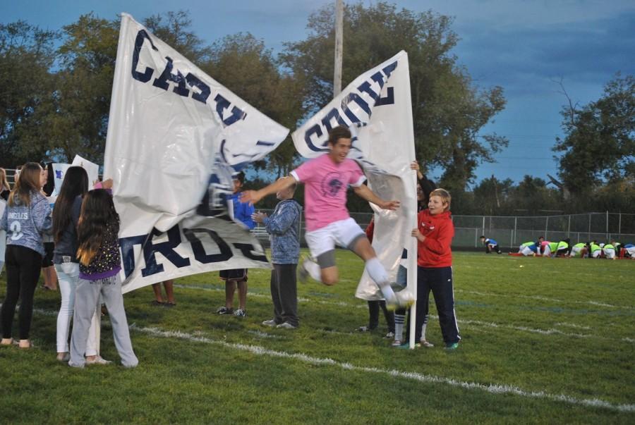 Michael Arenburg bursts onto the field during the Homecoming soccer game.