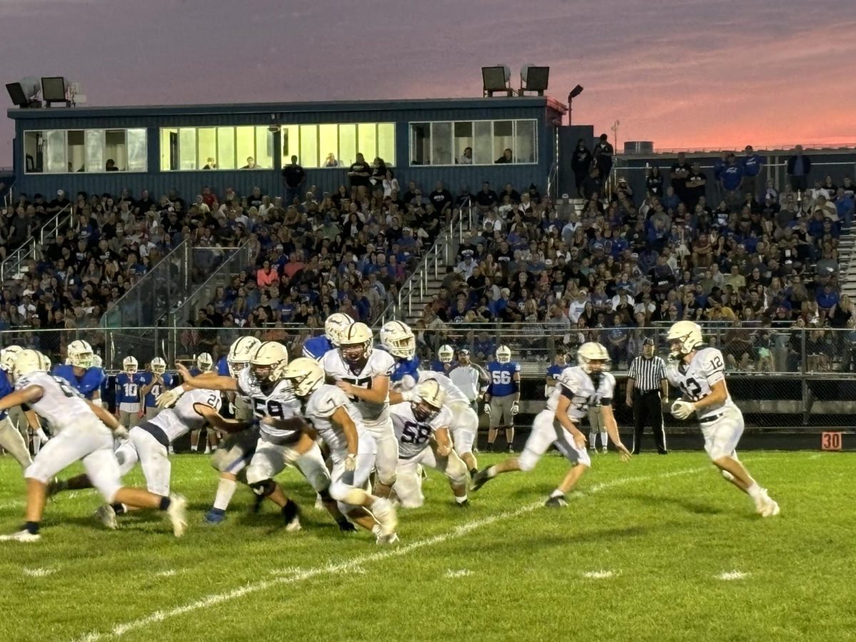 Senior RB Landon Barnett takes a pitch from senior QB Peyton Seaburg in Friday's 27-3 victory over Burlington-Central.